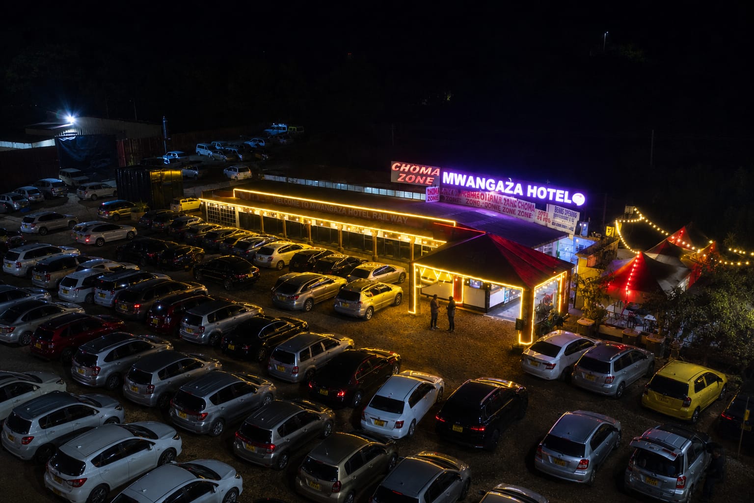 Mwangaza Hotel (Railways) Eldoret — Choma Zone at night with full parking